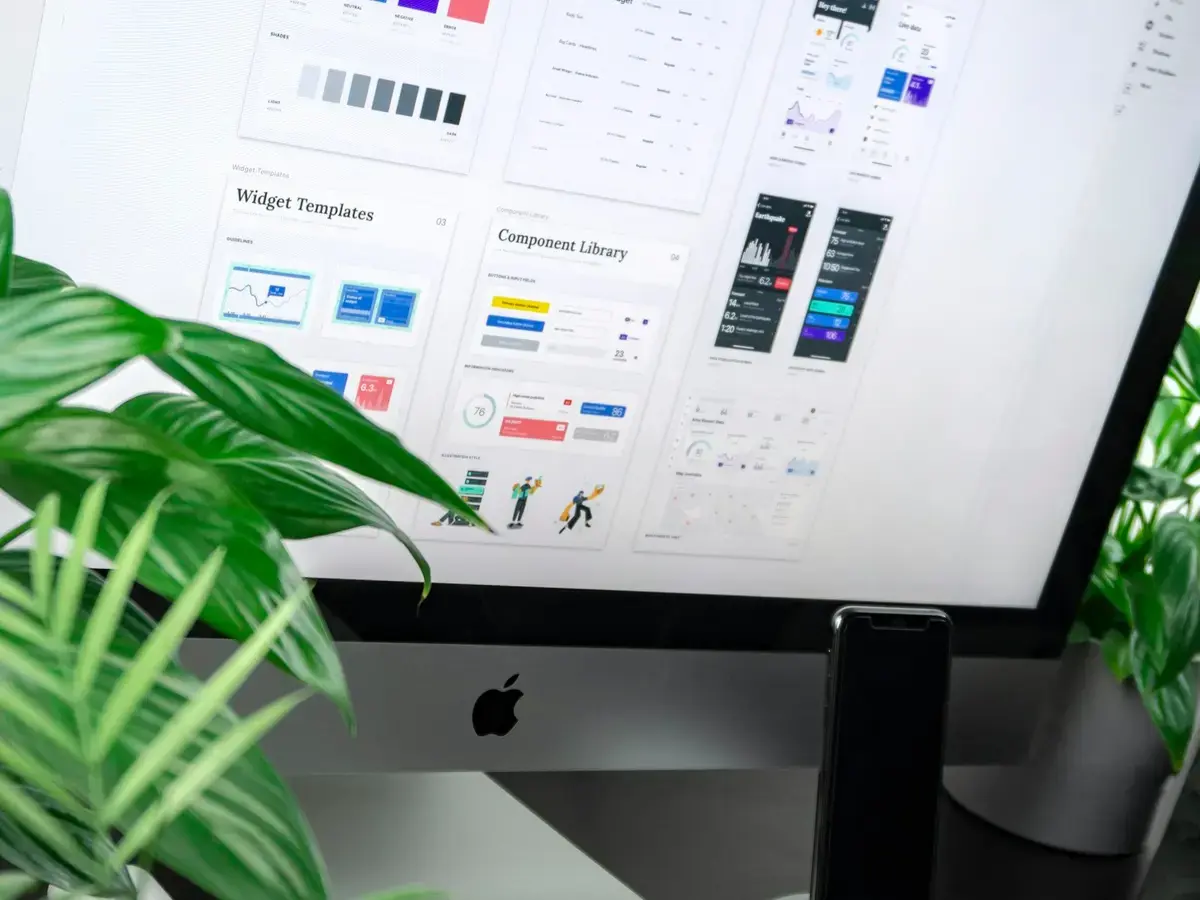 Design system with colour palettes, text styles and components on a studio monitor
